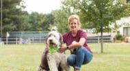 A MHS staff member with a dog outside.