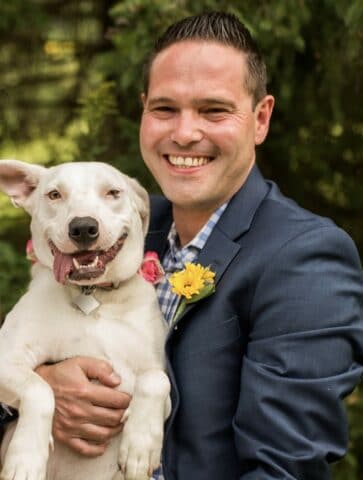 man holding a happy dog.