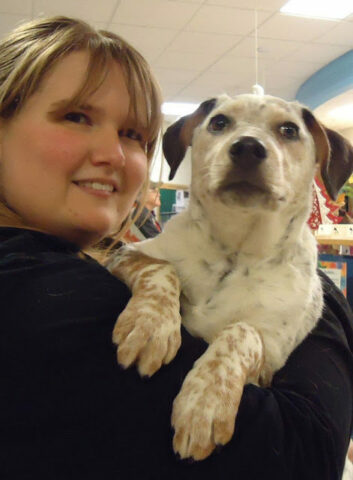 dog being held by woman.