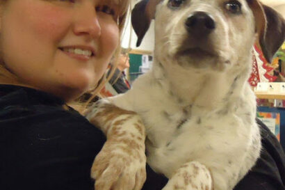 dog being held by woman.