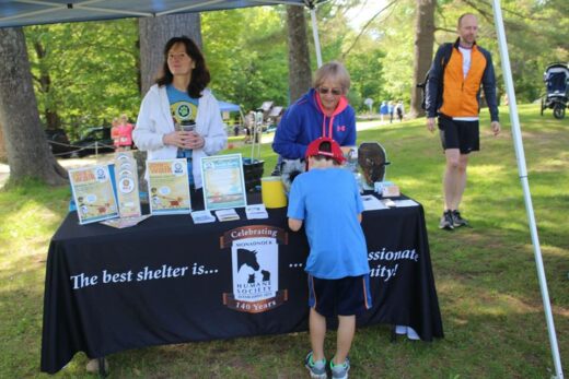 A MHS table in a tent at an event.