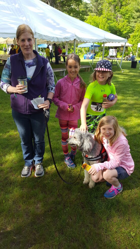 A family with a dog.