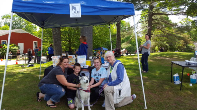 A family petting a dog.