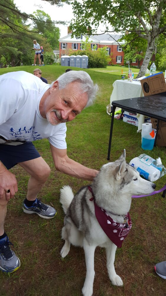 A man petting a dog.