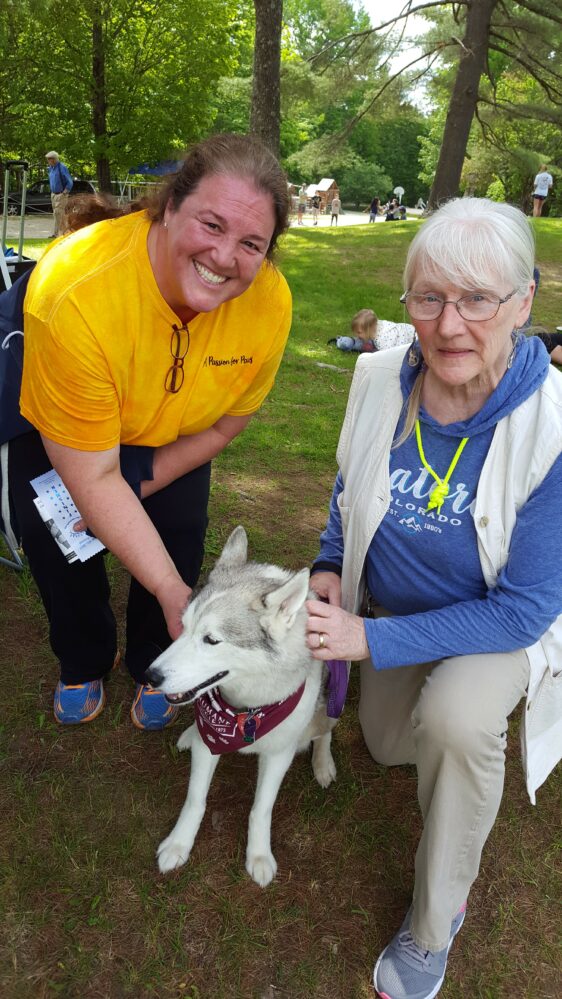 Two women with a white dog.