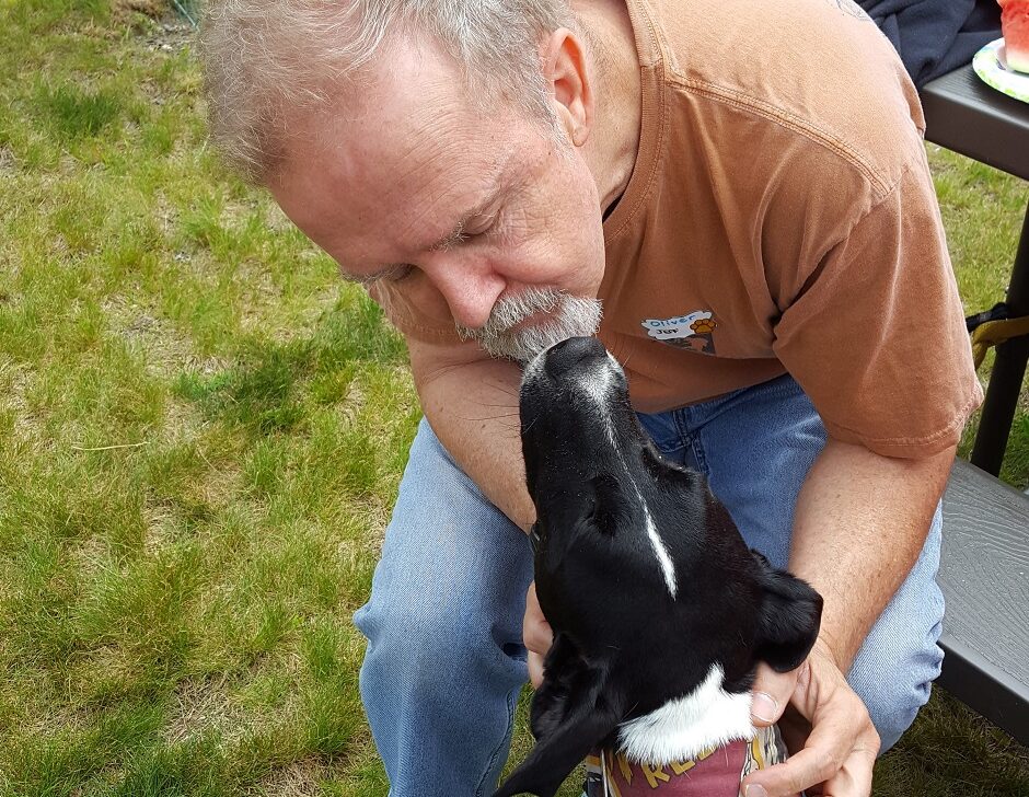 dog kissing his owner.
