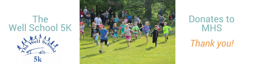 A group of young students running outside.