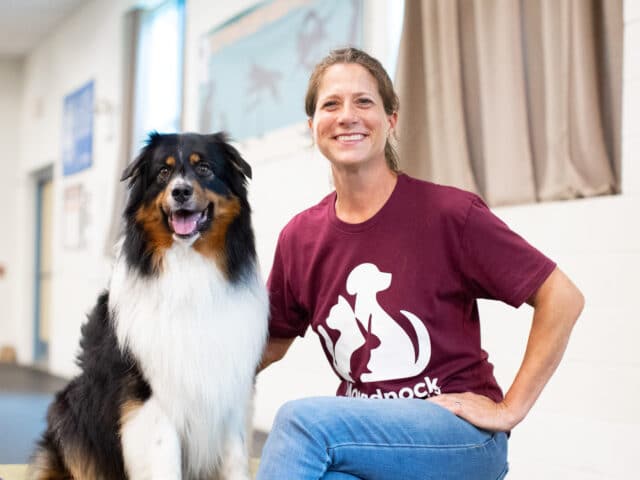 An MHS dog trainer alongside a dog.
