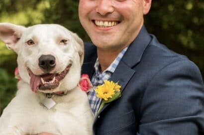 man holding a happy dog.
